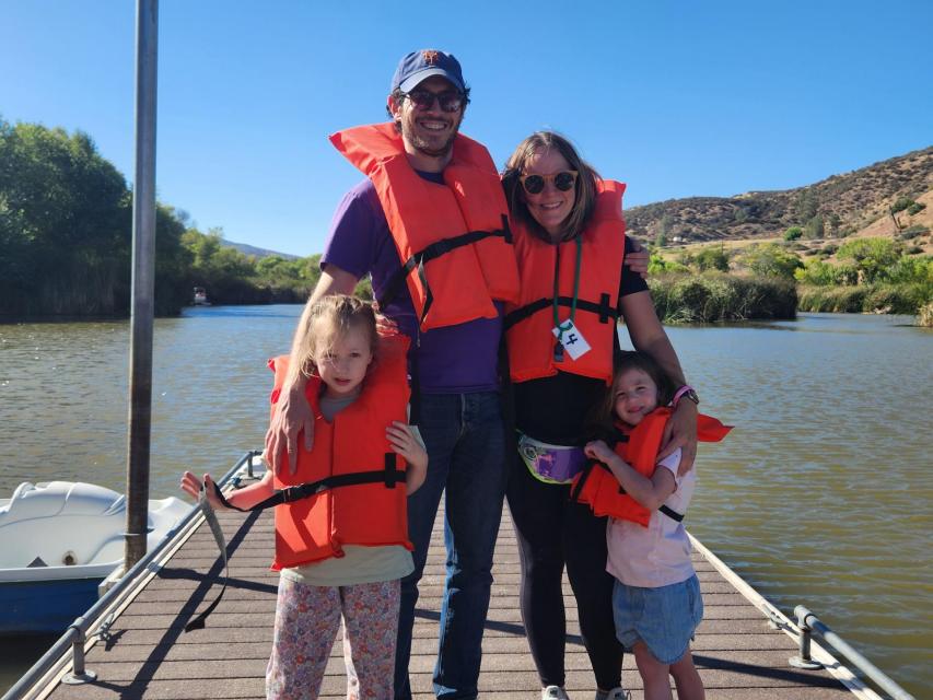 Family in life jackets ready to board a paddle boat on the lake at The Painted Turtle 