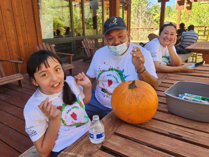 Family carving pumpkins on the Dining Hall porch at The Painted Turtle 