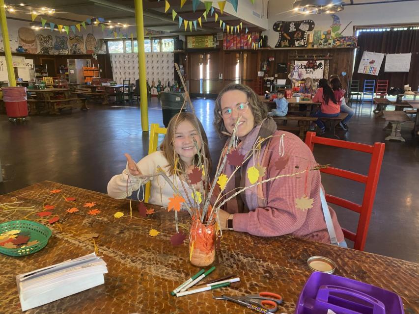 Mom and daughter make fall thankful tree for dining hall table