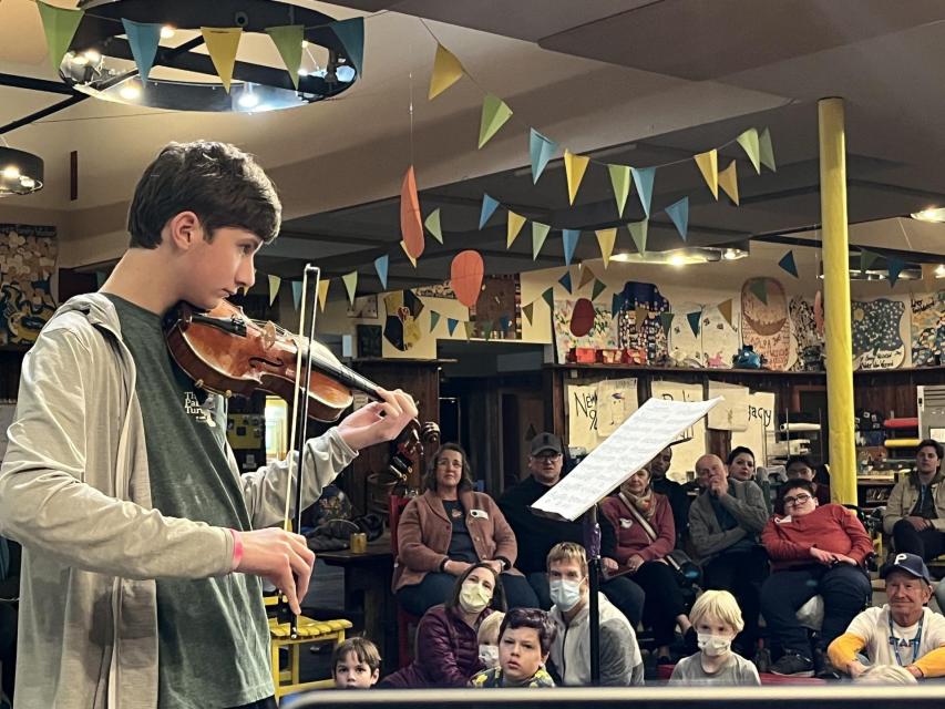 Camper playing his violin at Stage Night 