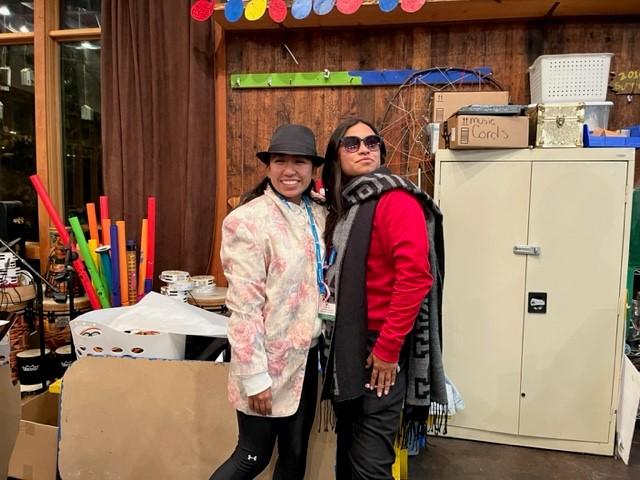 Two volunteers dressed up in detective costumes