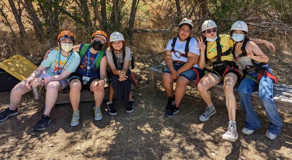 A group of campers and counselors at high ropes