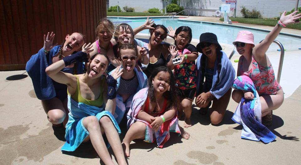 A group of campers and counselors at the pool