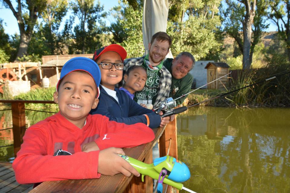 Group of boys lined up on the dock fishing! 