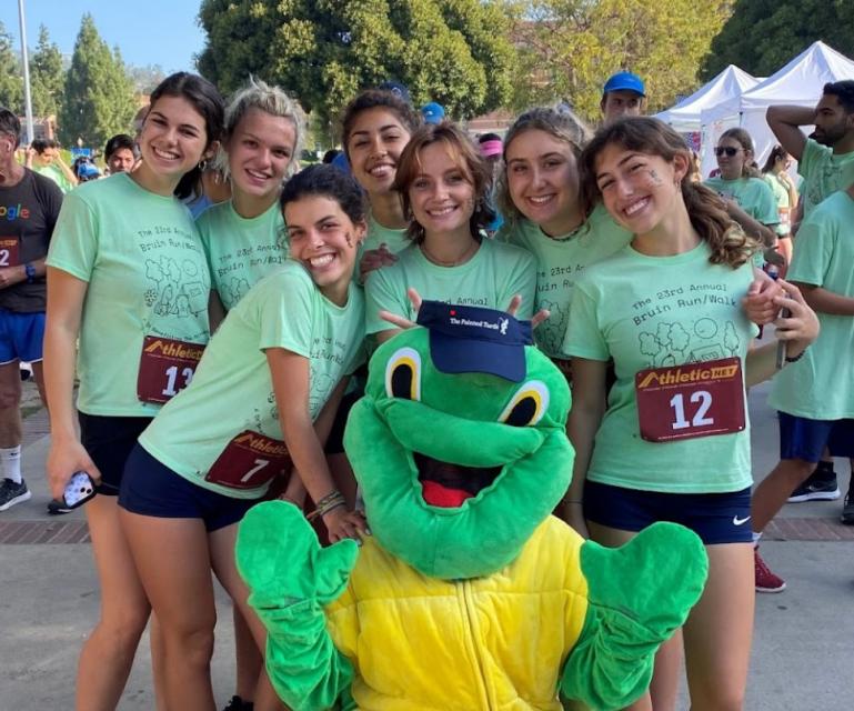 Team Fartlek, group of girls pictured with the turtle mascot ready to race in the UCLA Bruin Walk/Run