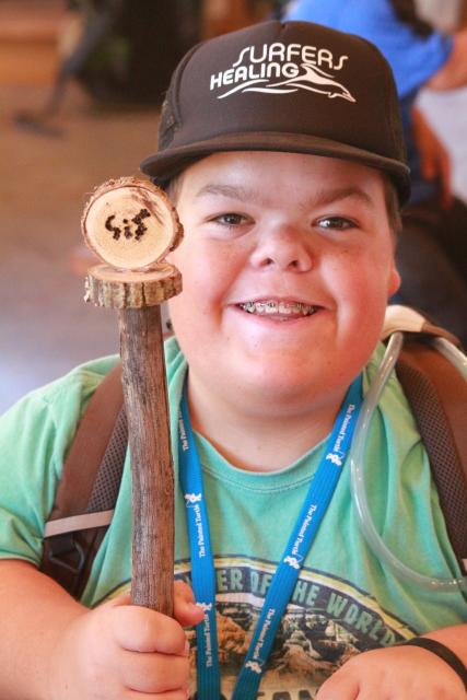 Boy holding woodshop project